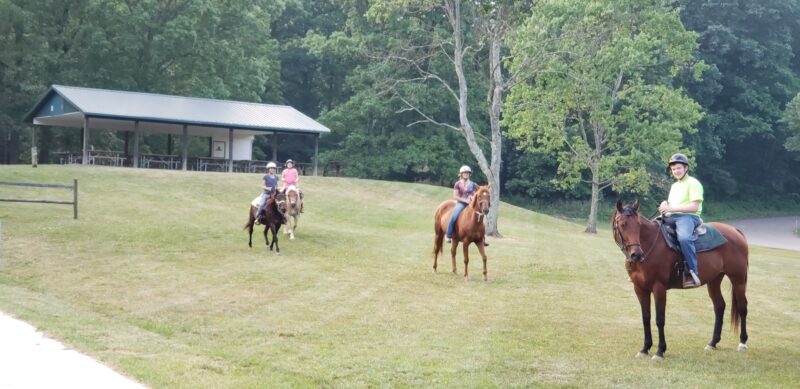 T-L Photos/JENNIFER COMPSTON-STROUGH Riders enjoy exercising their horses Thursday at the Wilbur “Gibby” Gibson Horse Camp at Barkcamp State Park. The park will host Camp WILD for children on July 20-21.